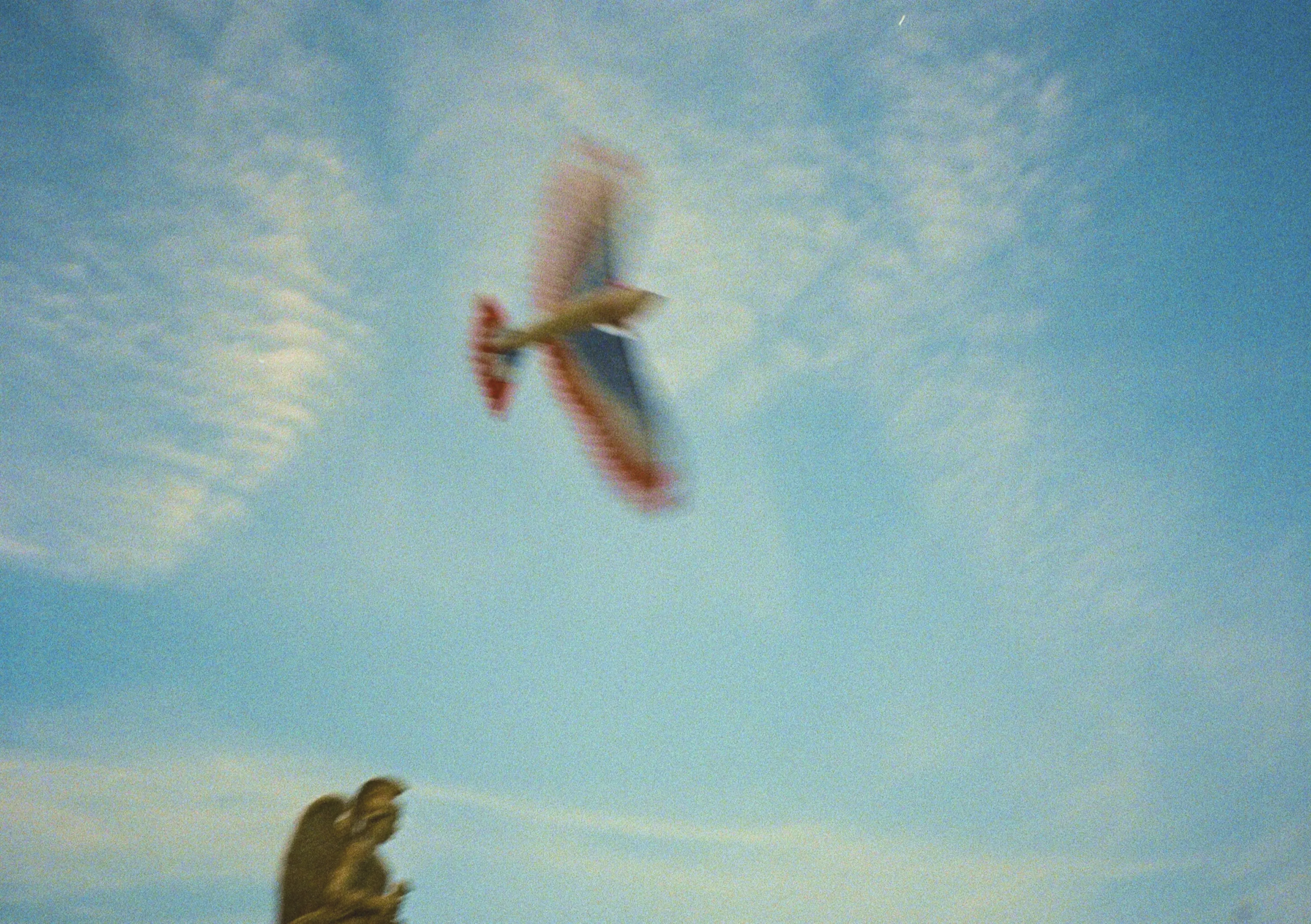 Soft blue sky with an ultralight soaring